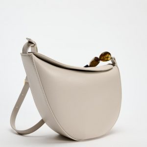 Asymmetric stone decorative shoulder bag